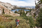 Lolo Hiking with May Lake in Background Lolo Hiking with May Lake in Background