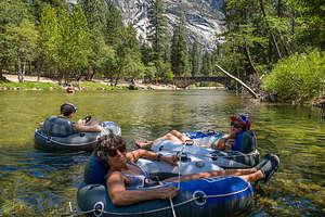 The ladies being pulled behind the raft on our trip down the Merced