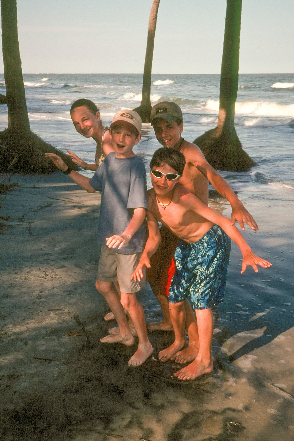 Kids "skim boarding" under palmetttos Kids "skim boarding" under palmetttos